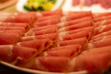 Thin slices of beef meat, ready to be cooked in hot pot, popular Chinese dish