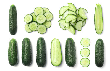 Set with sliced cucumbers on white background, top view