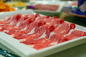 Thin slices of beef meat, ready to be cooked in hot pot, popular Chinese dish
