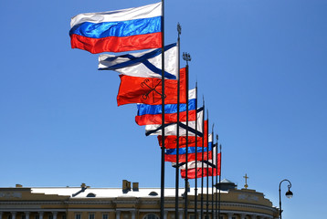 Fototapeta na wymiar different Russian Flags above buildings roof