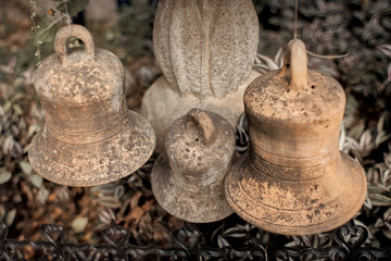 Old hanging clay bells against dried garden
