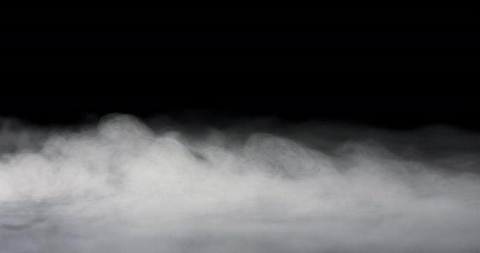 heavy fog passing across a black background.