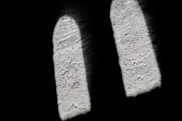 sunlit projections of windows against shadow
