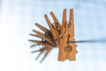 wooden clothespins pinned on a rope. Selective focus. Blur.