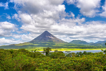 Amazing view of beautiful nature of Costa Rica with smoking volcano Arenal background. Panorama of volcano Arenal reflected on wonderful picturesque lake, La Fortuna, Costa Rica. Central America. © Valerija Dmitrijeva