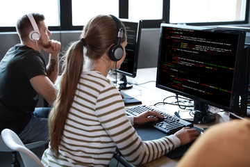 Professional programmers working with computers in office