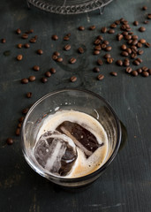 Two ice cubes in a cup of tasty coffee.