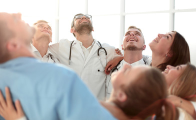 Fototapeta premium close up. group of happy doctors standing in a circle
