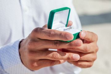 
Engagement ring for romantic outdoor elopement marriage proposal when man proposing and holding up an engagement ring in box 