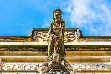 Witch on broom gargoye statue on the Lesser Town Bridge Tower at the end of Charles Bridge in Prague, Czech Republic