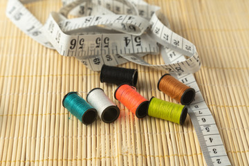 Fototapeta na wymiar sewing thread with a measuring tape textile