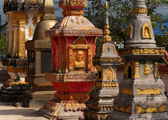 stupas as memorials decorated with golden and red colors in a buddhist temple in southeast asia
