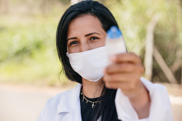 Female Doctor Checking Temperature Using Infrared Thermometer, Tool for detect Coronavirus or Covid-19, the lady in the car.