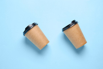 Takeaway cups for drink on color background