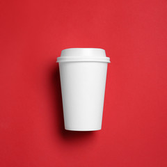 Takeaway cup for drink on color background