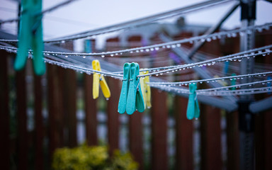 Clothes pegs on a wet clothes line