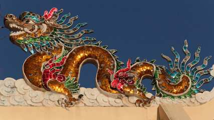 glass mosaic dragon image as roof top decoration in a chinese temple in the city of savannakhet lao PDR