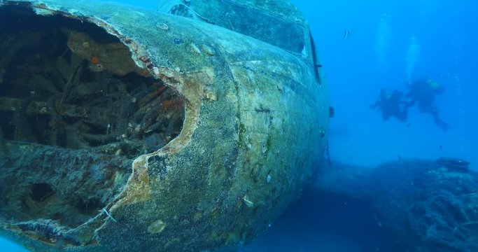 exploring underwater air plane wreck fish around ocean scenery of airplane scuba divers to enjoy