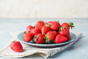 Plate  with ripe strawberry on table