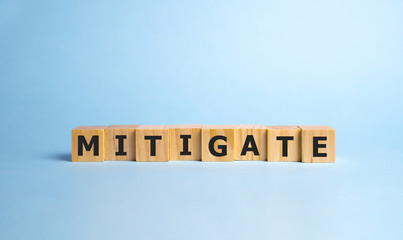 MITIGATE word made with building blocks, business concept.