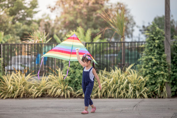 Close-up view of cute girl playing with sports (kite sport), learning outside the classroom during the summer semester and making good use of leisure time.