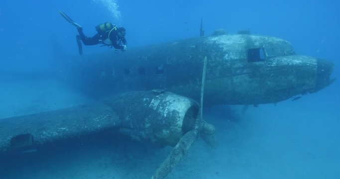 exploring underwater air plane wreck fish around ocean scenery of airplane scuba divers to enjoy