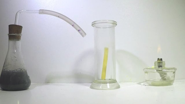 A cylinder glass is filled wih oygen, and burning sulphur lowered into the glass, the sulphur burns with a blue flame, producing yellow sulphur dioxide gas.