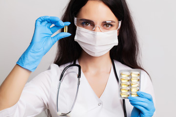Medicine concept, female doctor holding pills prescribed for patient treatment