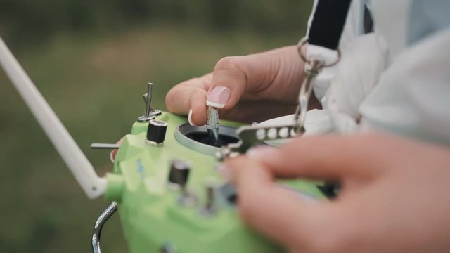 Closeup female hands remote control sticks of control of FPV racing drone