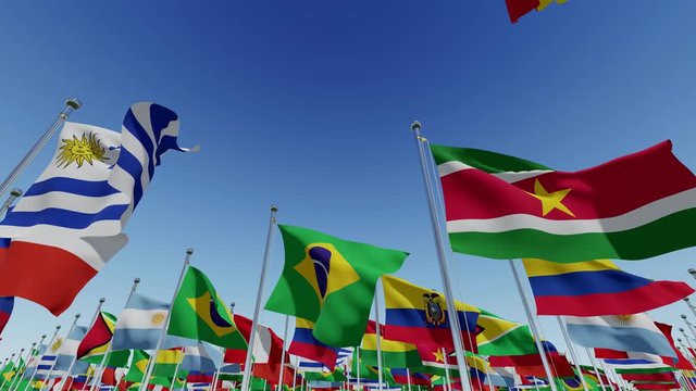 Many South America countries flagsv. Various world flags waving on flagpoles against blue sky. 3d rendering animation.