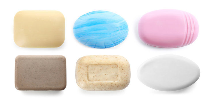 Set of different soap bars on white background, top view