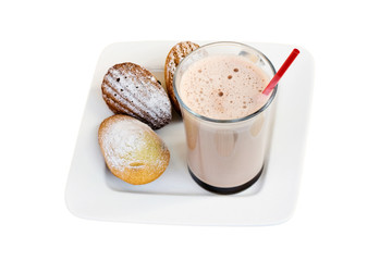 Glass cup of cocoa with french biscuit madeleine on the white plate. Isolated on white background.