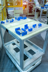 Fototapeta na wymiar warehouse robot car carries cardboard box assembly in factory