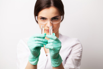 Medicine concept, doctor female in clinic holding test tubes with experimental vaccine