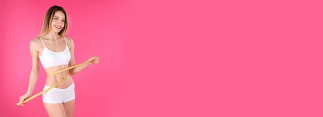 Slim woman measuring her waist on pink background, space for text. Banner design