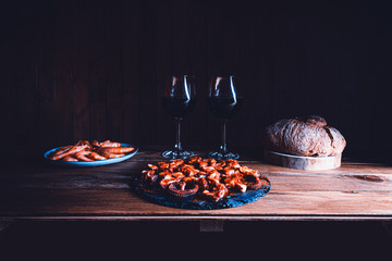 Still life style of octopus, prawns, bread and wine glasses. Seafood concept. Copy space