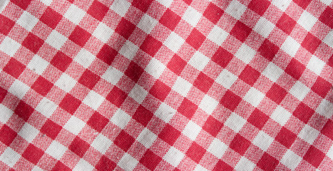 Real linen picnic tablecloth. Red and white checkered high detailed fabric background.