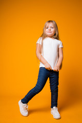 portrait of positive cheerful caucasian child girl posing at camera. children's emotions, happiness