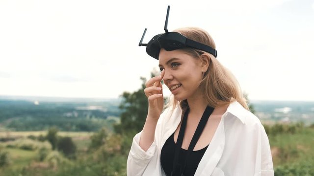 Girl with FPV glasses smiles, there is a trace of glasses on her face