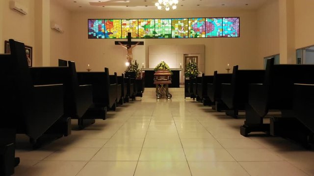 coffin with flowers in chapel