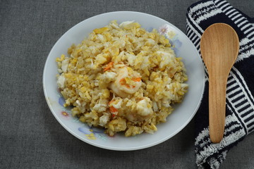 Famous luxury fried cooked jasmine rice with peeled fresh shrimp, crab meat and chicken egg on the plate. Traditional street food in Asia restaurant. Ancient menu in party. 