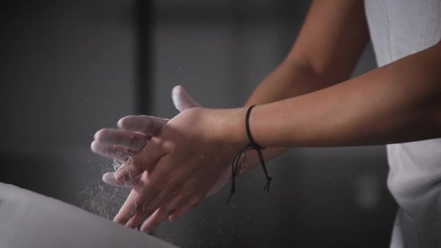 Female Weighlifter Putting Chalk on Her Hands Super Slow Motion
