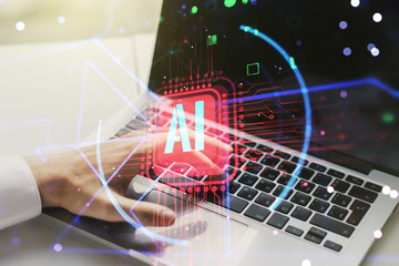 Double exposure of creative artificial Intelligence abbreviation with hand typing on computer keyboard on background. Future technology and AI concept