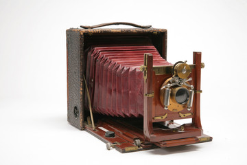 Vintage large-format view camera with bellows extended.  Three-quarters view to the right. Isolated and shot of white background	