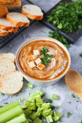 squash cream soup served with a wooden spoon 