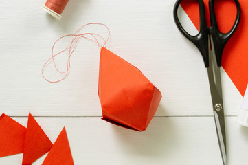 Step by step instructions for making origami paper lantern on christmas tree. Children diy project