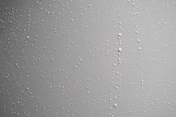 Rain drops on a metal wall panel