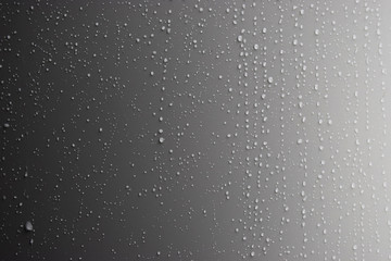 Obraz premium Rain drops on a metal wall panel