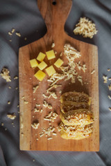 Selective focus photo of top view Cheese cookies on cutting board. Kaastangels are cookies made from a mixture of flour, eggs, margarine, and grated cheese. 