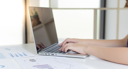 Financial businessmen use laptop to analyze marketing strategies and real estate data to reduce company taxes for their customers, Accounting and Tax concept.